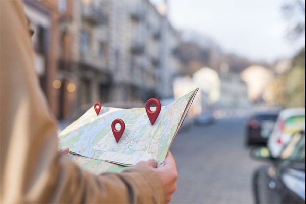 A person looking at a map with location pins on Google Business Profile